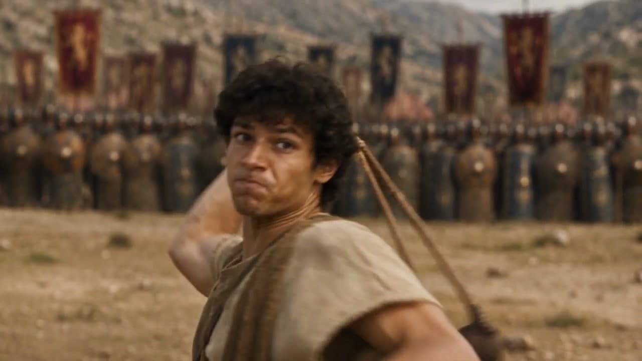 A young archer and armored commanders in a cinematic battlefield sequence